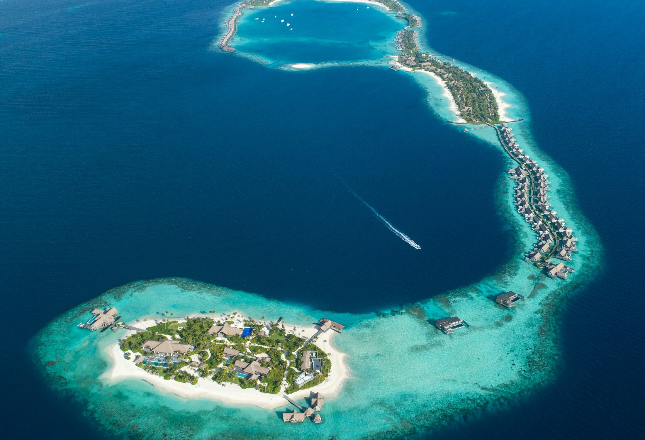 Aerial view of a Maldives island resort and turquoise reef